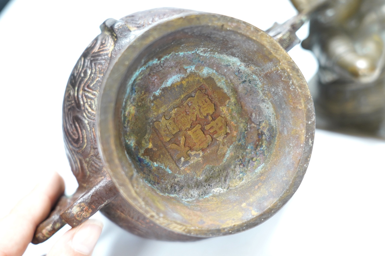 A Chinese bronze censer and cover, a Chinese bronze bowl and an Indian bronze seated deity, tallest 19cm high. Condition - fair some general scuffs and wear, the figure has a chip